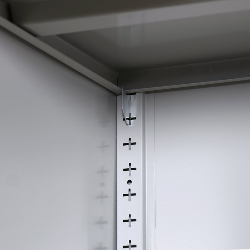 Adjustable shelf support and slot detail inside a steel office cabinet